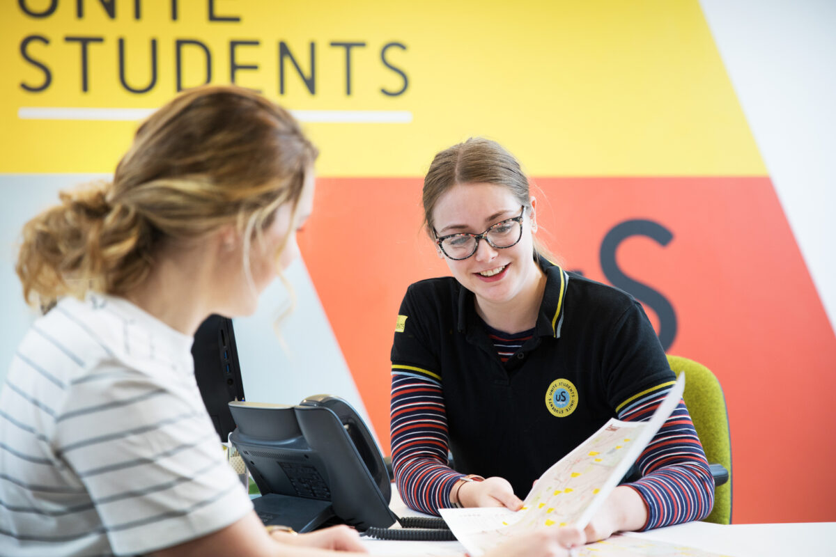 A uS staff member helps a student, just as our teams help students in Leeds